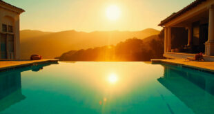 Empty infinity pool reflecting golden sunset at luxurious Bel-Air mansion, overlooking Los Angeles hills at golden hour