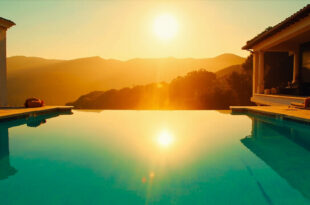 Empty infinity pool reflecting golden sunset at luxurious Bel-Air mansion, overlooking Los Angeles hills at golden hour