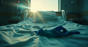 Empty hospital bed with blue medical sling bathed in dawn light in sterile hospital room, signifying recovery