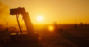 Abandoned military base with grounded aircraft and unused missile defense systems at desert compound during dusk after strike
