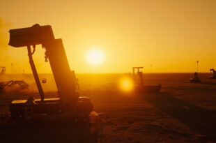 Abandoned military base with grounded aircraft and unused missile defense systems at desert compound during dusk after strike