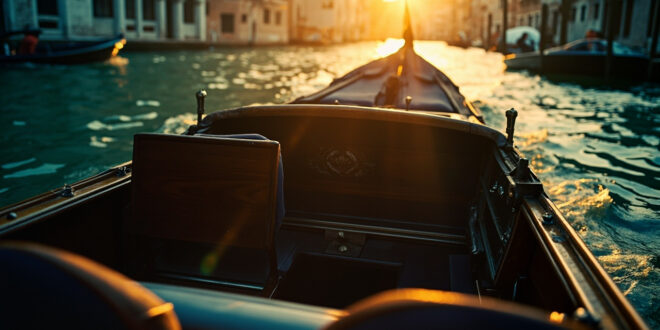 Empty ornate water taxi drifts through deserted Venetian canals at morning, bathed in gold and blue light