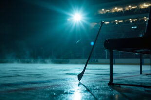 Abandoned hockey stick leaning against empty bench in deserted ice hockey rink at twilight, equipment scattered on ice