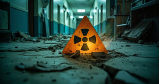 Abandoned hospital corridor with structural damage displaying cracked radiation warning signs in war-torn medical facility