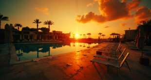 Deserted Mediterranean resort pool with scattered towels and empty beach chairs at sunset facing dark waters