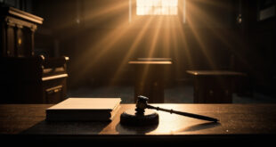 Empty federal courtroom with gavel and legal documents on judge's bench after proceedings, illuminated by dramatic lighting