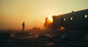 Twisted metal debris from aircraft wreckage scattered across abandoned airport tarmac at dawn, shrouded in morning mist