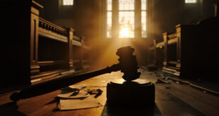 Empty courtroom with judge's gavel and legal documents on bench at dawn, awaiting political corruption trial