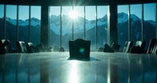 Empty chair with nameplate at oval conference table overlooking Rocky Mountains, symbolizing diplomatic absence