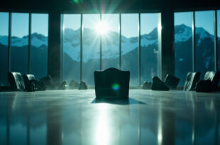 Empty chair with nameplate at oval conference table overlooking Rocky Mountains, symbolizing diplomatic absence