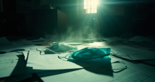 Surgical masks scattered across official documents on an empty desk in an abandoned government office investigation room