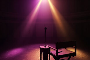 Empty spotlight illuminates vintage microphone and director's chair with folded script on abandoned theater stage at twilight