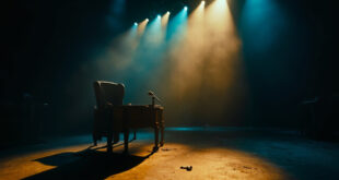 Empty television talk show set with darkened stage lights, abandoned host chair and lone microphone after final broadcast