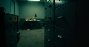 Empty filing cabinets with locked drawers and sealed manila folders on desk in abandoned government office at dusk