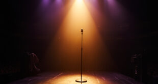 Empty concert stage with abandoned microphone stand in spotlight amid darkened venue, symbolizing a music legend's passing