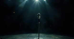 Solitary vintage microphone stand illuminated by spotlight on empty, darkened concert stage after final show