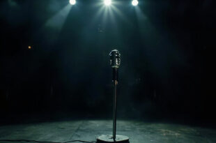Solitary vintage microphone stand illuminated by spotlight on empty, darkened concert stage after final show