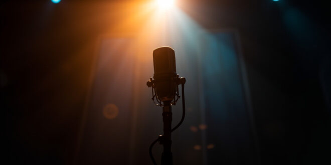 Empty microphone stand in a warmly lit recording studio, symbolizing awaited return to music as therapy