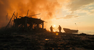 Burned debris and empty rescue boat on shore of abandoned coastal area after devastating fire at migrant shelter