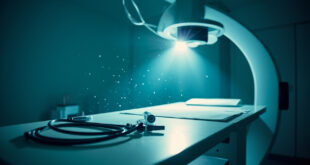 Endoscope and medical charts on empty examination table with unused diagnostic equipment in sterile medical room