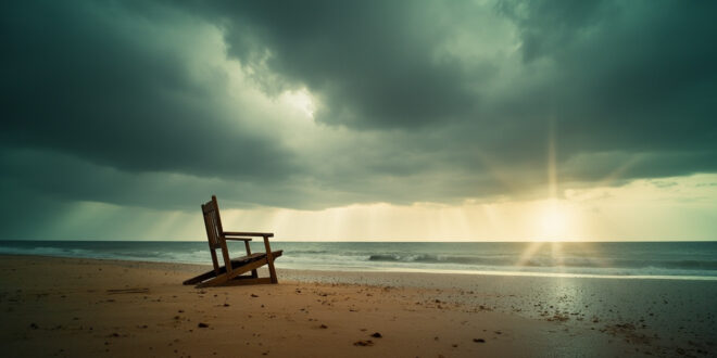 Empty wooden beach chairs on rain-soaked sand at a deserted German coastal beach under stormy grey summer skies