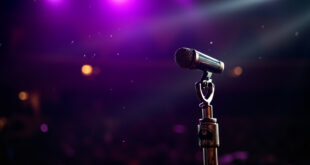 Solitary vintage microphone with bat symbol stands silently on an empty, dimly lit concert stage bathed in purple light