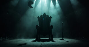 Empty ornate throne on a darkened gothic concert stage with abandoned microphone stand and bat silhouette