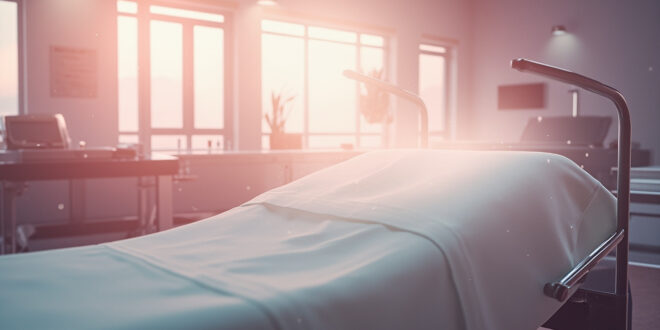 Empty surgical suite with pristine instruments on metal table and freshly made medical bed in softly lit sterile facility