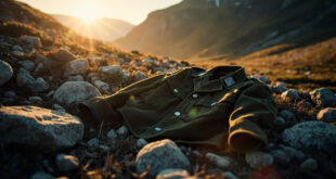 Abandoned Wehrmacht uniform jacket lying on rocky terrain along an empty Alpine hiking trail in Swiss mountains