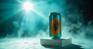 Aqua-colored papaya-designed soda can displayed on stand in clean product photography studio with dramatic lighting