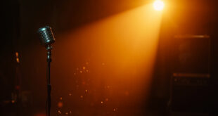 Vintage microphone and abandoned recording equipment in a dimly lit, empty studio with amber lighting and dust particles