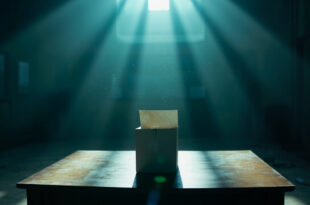 Sealed ballot box with cast votes sits on empty table in abandoned polling station after voting hours