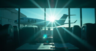 Empty passenger aircraft on tarmac at departure gate in deserted airport terminal at dawn with official documents visible