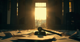 Scattered custody documents and a gavel on an empty judge's bench in an abandoned courthouse at dusk