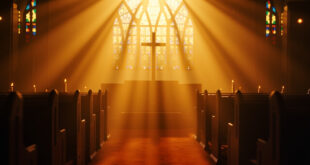 Empty church sanctuary with sunlight streaming through stained glass windows, illuminating wooden pews and altar cross