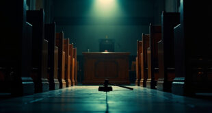 Empty courtroom with wooden benches and witness stand at dusk, gavel resting on judge's bench in solemn courthouse