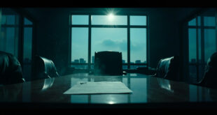 Empty executive chair behind mahogany desk in abandoned corporate boardroom at dusk, with resignation letter visible