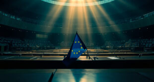 Empty European Parliament chamber with voting documents scattered across desks, EU flags drooping in the background