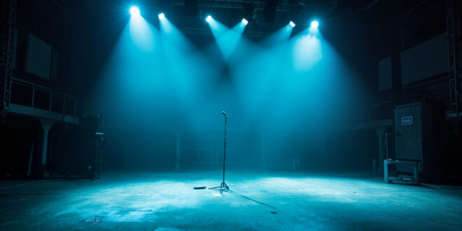 Abandoned Comedy Central studio at night with unmanned equipment, lone microphone on empty stage lit by neon blue lighting