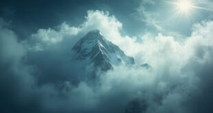 Snow-covered mountain peak engulfed by storm clouds in remote Karakoram range during harsh weather conditions