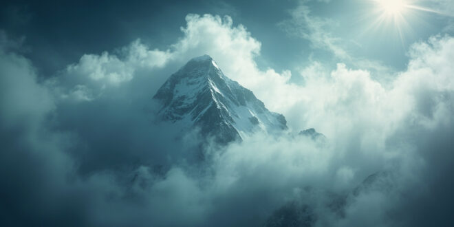 Snow-covered mountain peak engulfed by storm clouds in remote Karakoram range during harsh weather conditions
