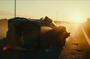 Overturned luxury car wreckage abandoned on empty Spanish highway at dawn, with atmospheric lighting in gray and gold