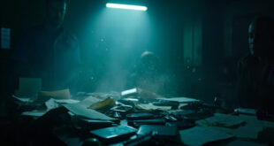 Confiscated smartphones and documents displayed on investigation desk in empty counter-terrorism evidence room