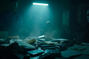 Confiscated smartphones and documents displayed on investigation desk in empty counter-terrorism evidence room