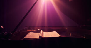 Abandoned grand piano with closed lid and unopened sheet music in a quiet music studio at twilight bathed in purple and gold light