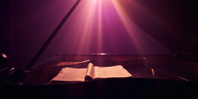 Abandoned grand piano with closed lid and unopened sheet music in a quiet music studio at twilight bathed in purple and gold light