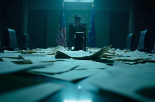 Abandoned negotiation table with scattered trade documents in empty corporate boardroom featuring EU and US flags