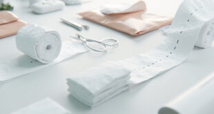 White medical bandages and surgical gauze with visible stitches in sterile clinical setting