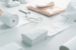 White medical bandages and surgical gauze with visible stitches in sterile clinical setting