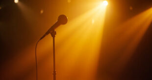 Vintage microphone on empty stand bathed in golden light within a quiet recording studio, symbolizing absence and resilience
